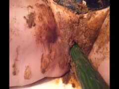 A mischievous teenager fills her shaved pussy with moist excrement